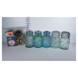 5 blue glass quart jars with glass lids and a bag