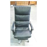 Executive desk chair with leg rest.