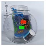 Fish bowl, fish food and aquarium rocks