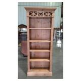 Pine bookcase with primitive cut-out decor.