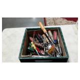 Milk crate full of assorted screwdrivers, nut