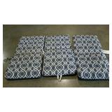 Three patio chair cushions, some fading.