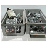 Two stackable bins of assorted hardware. Clamps,