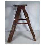 Small wooden step ladder with lots of paint