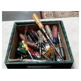 Milk crate full of assorted screwdrivers, nut