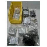 Small stackable bin of assorted screws and bolts.