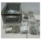 Stackable bin filled with bags of assorted bolts,