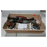 Bin with assorted hand tools and bag of dowels.