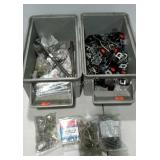 Two stackable bins of assorted hardware. Clamps,