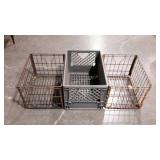 Three dairy crates. Two older metal ones and