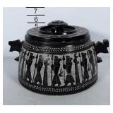 Stone dish with stone lid and wooden handles.