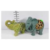 Elephants, two statues, one has battery candle