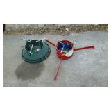 Two Christmas tree stands. One is heavy iron for