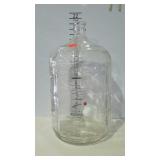 Five gallon clear glass water bottle. Marked