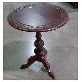 Parlor Table with heavy carvings, tri leg base,