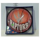Battery powered clock, new in box.  RAPTORS.