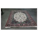 Area rug with floral patterned border, red.
