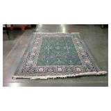 Area rug with floral patterned border, green.