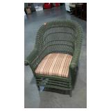 Painted wicker patio chair with upholstered seat.