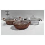 3 covered casserole dishes with carriers, one