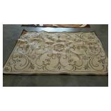 Indoor/outdoor rug with flower and vine design.