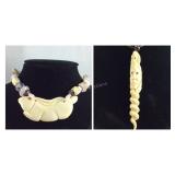 Two necklaces one spiral design and one rabbit