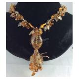 Amber colored beaded necklace and a pair of
