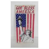 God Bless America sign, shows wear, but Lady