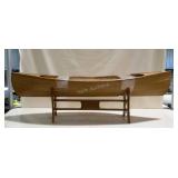 Boat shaped coffee table with glass top. Some