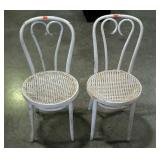 Two bent wood chairs with rattan seats. Painted
