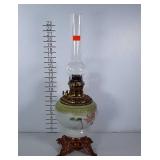 Tall oil lamp with painted globe. Base where feet