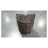 Wicker laundry hamper with attached lid. Half