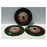 Three unused CARBORUNDUM 9" grinding wheels.
