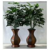 Pair of faux plants in decorative planters.