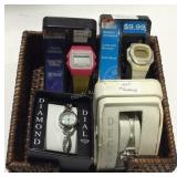 Four wrist watches in basket