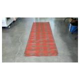 Woven wide runner rug in red and brown geometric