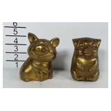 2 brass piggy banks. Both stand about 4 inches
