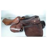 Two English riding saddles and one cover