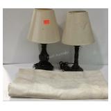 Two non matching bedside lamps and a cloth sack