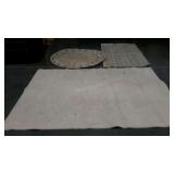 Three neutral colored area rugs. All need