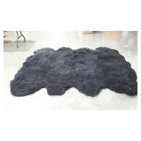Black faux fur rug. Approximately 6