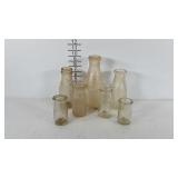 Lot of dairy bottles, various sizes and brands.