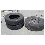 3 tires, one with a wheel, mixed brands/sizes