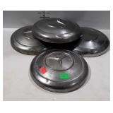 Four Mercedes hubcaps, well worn with some dents