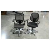Two rolling office/desk chairs with mesh backs.