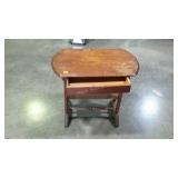 Table stand with single drawer and turned legs.