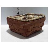 Small Longaberger basket with floral liner. 7" ×