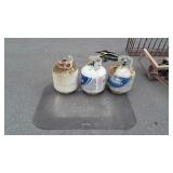 Three empty propane tanks and floor mat