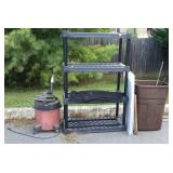 Trashcan with a couple golfclubs and racket, poly