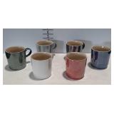 Six Le Creuset coffee mugs.